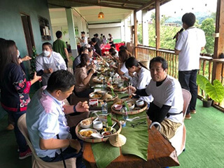 写真6. アカ族の茶料理を食べながら、プラヤプラー村で行われたガストロノミーティーツーリズム交流プログラムで日本人とタイ人参加者の間でメニュー作りをめぐって意見交換の一コマ。