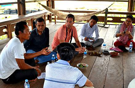 Mr. Hyma is seen listening to a group of rural Cambodian community members (courtesy of Mr. Hyma).