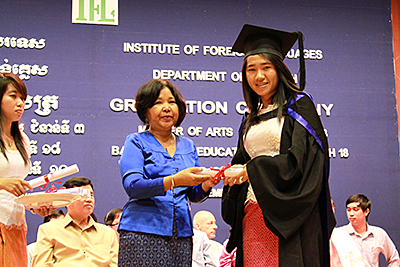In a graduation gown and a cap, Ms. Kry received her diploma (courtesy of Ms. Kry).